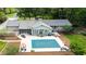 Aerial view showcases a home with a screened porch, large pool, patio, and beautifully landscaped backyard, perfect for outdoor living at 11 Pine Forest Dr, Siler City, NC 27344