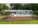 Expansive backyard featuring a covered pool, patio, and lush greenery at 11 Pine Forest Dr, Siler City, NC 27344