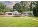 View of backyard showing a covered pool, patio, and sprawling lawn at 11 Pine Forest Dr, Siler City, NC 27344