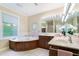 Luxurious bathroom with a soaking tub, double vanity, and elegant decor at 11 Pine Forest Dr, Siler City, NC 27344