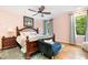 Charming bedroom with a wooden bed frame, cozy seating, and natural light from the windows at 11 Pine Forest Dr, Siler City, NC 27344