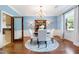 Bright and airy dining room features a round table, classic china cabinet, and hardwood floors at 11 Pine Forest Dr, Siler City, NC 27344