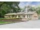 Spacious home with a beautiful brick facade, manicured landscaping, and an expansive driveway leading to an attached garage at 11 Pine Forest Dr, Siler City, NC 27344