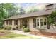 Charming brick home with a stone walkway leading to the entrance, complemented by a bay window and lush greenery at 11 Pine Forest Dr, Siler City, NC 27344
