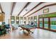Spacious game room features a pool table, beamed ceilings, tile floors, and access to the outdoor pool at 11 Pine Forest Dr, Siler City, NC 27344