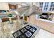 Close up of a stainless range hood over the kitchen island's gas cooktop on granite countertop at 11 Pine Forest Dr, Siler City, NC 27344
