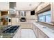 Well-lit kitchen showcases island cooktop, light wood cabinets and countertops, plus stainless hood at 11 Pine Forest Dr, Siler City, NC 27344