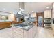 Spacious kitchen featuring a large center island with gas cooktop and stainless steel range hood at 11 Pine Forest Dr, Siler City, NC 27344
