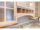 Close-up of frosted upper kitchen cabinets and tile backsplash over light countertops and cabinets at 11 Pine Forest Dr, Siler City, NC 27344