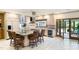 Wide kitchen view of island with seating, stainless appliances, and French doors to backyard at 11 Pine Forest Dr, Siler City, NC 27344