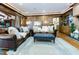 Inviting living room features wood paneling, an ottoman, and a plush rug for a comfortable atmosphere at 11 Pine Forest Dr, Siler City, NC 27344