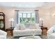 Bright living room with bay window, white furniture, and views of the outdoors at 11 Pine Forest Dr, Siler City, NC 27344