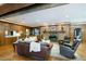 Cozy living room with wood paneling, a brick fireplace, and comfortable leather furniture at 11 Pine Forest Dr, Siler City, NC 27344