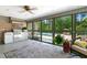 Enclosed outdoor kitchen featuring modern appliances and serene views of the pool and surrounding landscape at 11 Pine Forest Dr, Siler City, NC 27344