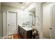 Bathroom featuring a double sink vanity with dark wood cabinets, and a large mirror at 1108 Orchard Stream Dr, Haw River, NC 27258