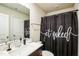 Bathroom featuring a shower with a 'get naked' curtain and a white countertop with a sink at 1108 Orchard Stream Dr, Haw River, NC 27258