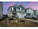 Charming two-story home with a fresh exterior, attached garage, and neat front yard at 1108 Orchard Stream Dr, Haw River, NC 27258
