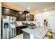 Modern kitchen featuring dark cabinetry, granite countertops, and stainless steel appliances at 1108 Orchard Stream Dr, Haw River, NC 27258