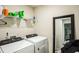 A laundry room with a washer and dryer and shelving, along with cleaning supplies at 1108 Orchard Stream Dr, Haw River, NC 27258