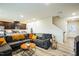 Inviting living room adjacent to the kitchen, featuring a comfortable couch and staircase at 1108 Orchard Stream Dr, Haw River, NC 27258