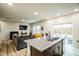 Open-concept space featuring a large living room, kitchen island, and sliding glass doors to the backyard at 1108 Orchard Stream Dr, Haw River, NC 27258
