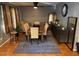 Spacious dining room with modern light fixtures, a large mirror, and hardwood floors at 1211 Odyssey Dr, Durham, NC 27713