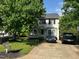 Traditional two-story home with a well-manicured lawn, mature trees, and a private driveway at 1211 Odyssey Dr, Durham, NC 27713