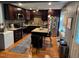 Well-equipped kitchen featuring dark cabinetry, modern appliances, a breakfast bar and hardwood floors at 1211 Odyssey Dr, Durham, NC 27713