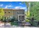 Two-story home with backyard, black fence, covered patio, and lush greenery at 1230 Wingstem Pl, Raleigh, NC 27607