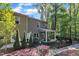 Two-story home with fenced yard, covered patio, and mature trees at 1230 Wingstem Pl, Raleigh, NC 27607