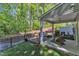 Covered patio, backyard deck, and fenced yard in a peaceful wooded setting at 1230 Wingstem Pl, Raleigh, NC 27607