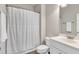 Bright bathroom featuring a shower with curtain, toilet, and vanity at 1230 Wingstem Pl, Raleigh, NC 27607