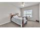 Cozy bedroom features a four-poster bed, side table, and a window with a desk, and carpeted floors with neutral walls at 1230 Wingstem Pl, Raleigh, NC 27607