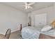 Well-lit bedroom features a ceiling fan, double closet, and neutral walls at 1230 Wingstem Pl, Raleigh, NC 27607