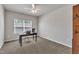 Bedroom featuring a computer desk by the window, ceiling fan, and carpeted floors with neutral walls at 1230 Wingstem Pl, Raleigh, NC 27607