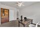 Bedroom featuring a computer desk, ceiling fan, carpeted floors, a bookshelf, and neutral walls at 1230 Wingstem Pl, Raleigh, NC 27607