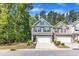 Attractive two-story townhome with two-car garage, stone accents, and charming front garden at 1230 Wingstem Pl, Raleigh, NC 27607