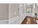 Bright and inviting foyer with hardwood floors, white wainscoting, and elegant trim at 1230 Wingstem Pl, Raleigh, NC 27607