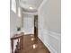 Beautiful hallway featuring hardwood floors, white wainscoting, and a classic console table at 1230 Wingstem Pl, Raleigh, NC 27607