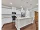 Bright, modern kitchen features granite counters, stainless steel appliances, and a large center island at 1230 Wingstem Pl, Raleigh, NC 27607
