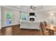 Bright living space with hardwood floors, fireplace, and access to outdoor patio at 1230 Wingstem Pl, Raleigh, NC 27607