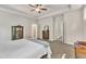 Spacious main bedroom featuring tray ceilings, with two doorways leading to an ensuite bathroom and a large walk-in closet at 1230 Wingstem Pl, Raleigh, NC 27607