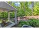 Serene outdoor patio area surrounded by a lush, green, wooded landscape at 1230 Wingstem Pl, Raleigh, NC 27607