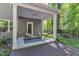 Covered patio with ceiling fan, rug, and two Adirondack chairs at 1230 Wingstem Pl, Raleigh, NC 27607