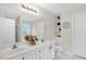 Bathroom with a double sink vanity, decorative shelving, and a large mirror at 1305 Montreux Ct, Mebane, NC 27302