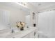 Bright bathroom with double sinks, white cabinets, a framed mirror, and shower with tub at 1305 Montreux Ct, Mebane, NC 27302