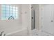 Bright bathroom with a large soaking tub, glass-enclosed shower, and tiled floors at 1305 Montreux Ct, Mebane, NC 27302