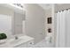 Clean bathroom with a single sink vanity, white cabinets, and marble-patterned flooring at 1305 Montreux Ct, Mebane, NC 27302