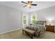 Comfortable bedroom with a ceiling fan, hardwood floors, and lots of natural light at 1305 Montreux Ct, Mebane, NC 27302