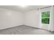 Bright bedroom with large window overlooking greenery and soft neutral colors at 1305 Montreux Ct, Mebane, NC 27302